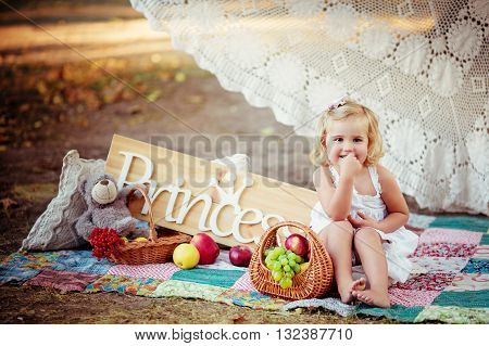Little happy girl in white dress outdoor