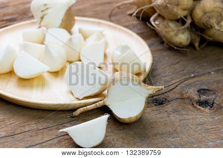 fresh cut asian jicama on wooden board