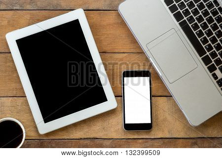 Office desk with blank screen smartphone cup of coffee tablet and labtop . Flat lay photo.Top view with copy space