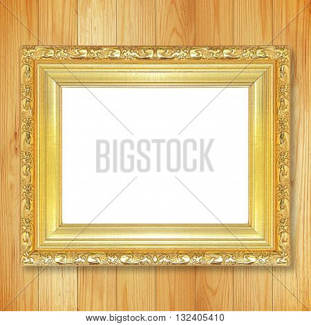 Antique gold frame on wooden wall;. Empty picture frame on wooden wall.