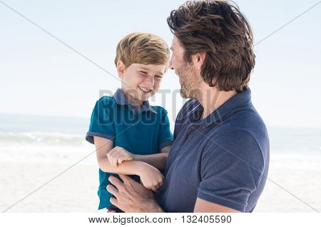 Child in father arms. Father day out with son. Father spending quality time with son.  
