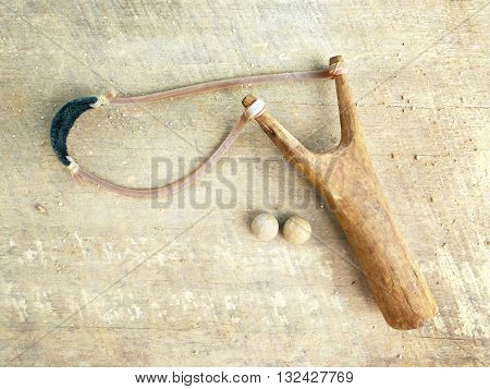 Catapult on wooden board,this image adjust color to dark and natural tone.