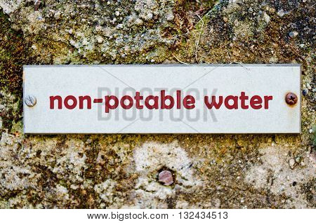 label for non potable water on old wall