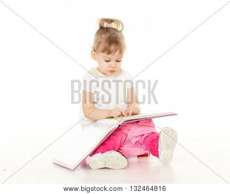 Pretty little girl  with a book sits on a pink baby potty on a white background.