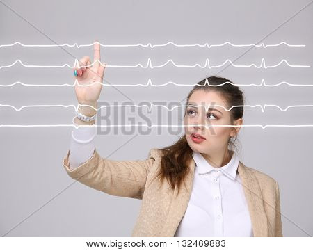 Doctor woman working with cardiogram lines
