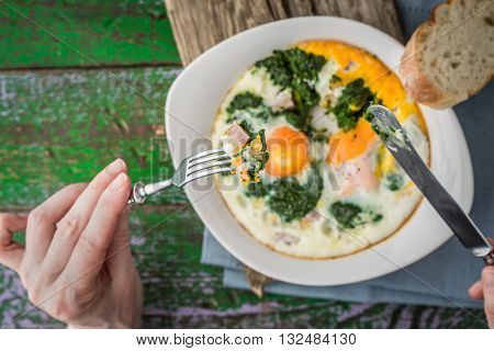 Eating Florentine eggs with purred spinach horizontal
