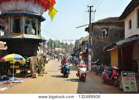 GOKARNA KARNATAKA INDIA - JANUARY 29 2016: People driving scooters in the crowded streets in Gokarna city