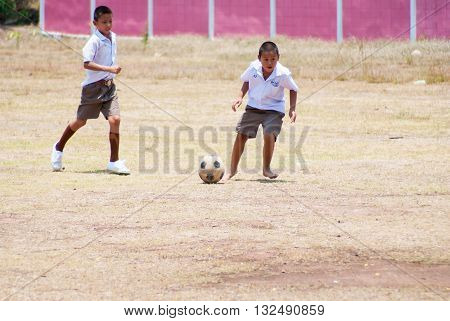 PHITSANULOK THAILAND - MAY 16 2016: Thai children play football after lesson at Huay hoen School.