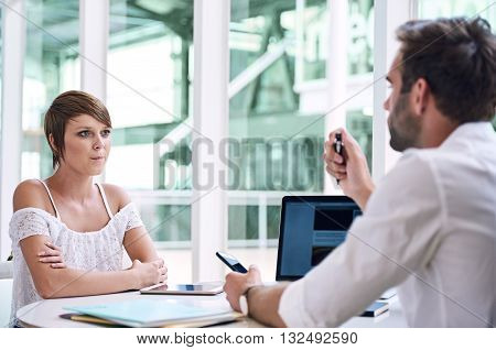 Successful young businesswoman getting financial advise from handsome male business consultant about her new small business venture that requires his specific expertise on the subject.
