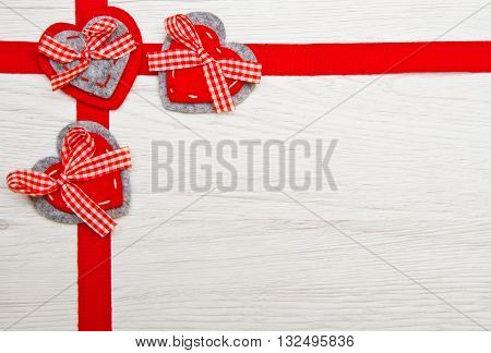 Valentines day toy heart and ribbon over wooden