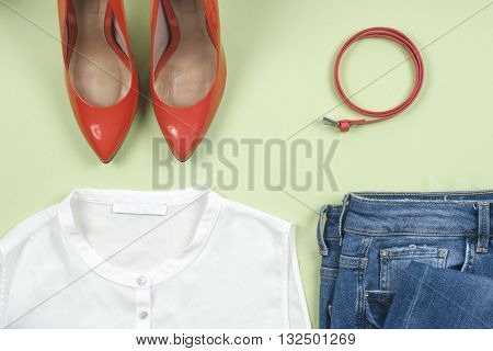 Women clothing set and accessories on light background.Top view different shoes on light background. Copy space for text.