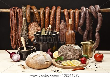 Assortment of meats, with bread, vegetables, pickled cucumbers, lard and spices
