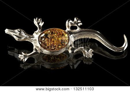 silver and amber brooch Lizard on black background