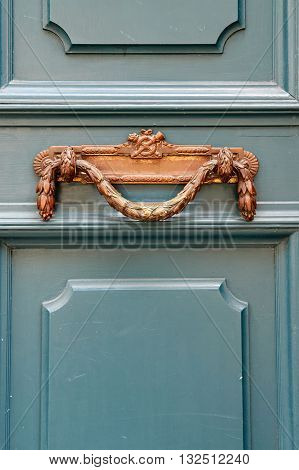 Luxury vintage door handle on a turquoise painted door in France