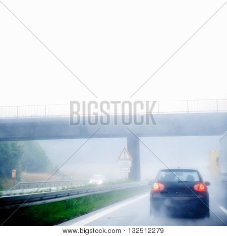 Highway traffic on a rainy day on German European autobahn with cars driving over 200 kmh