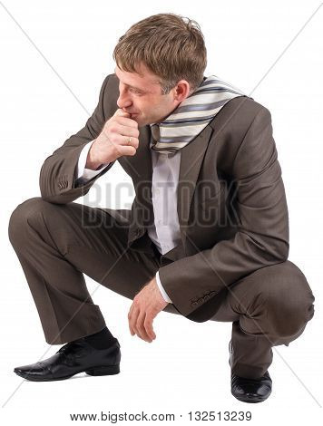 Businessman sitting on his haunches over white background