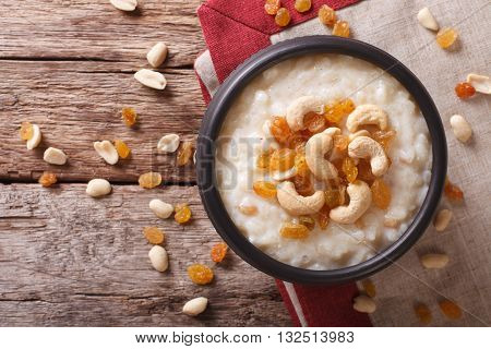 Tasty Rice Pudding With Nuts And Raisins Close-up. Horizontal Top View