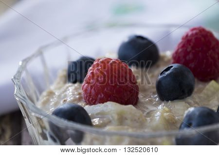 Homemade bircher muesli with summer fruits in glass dish