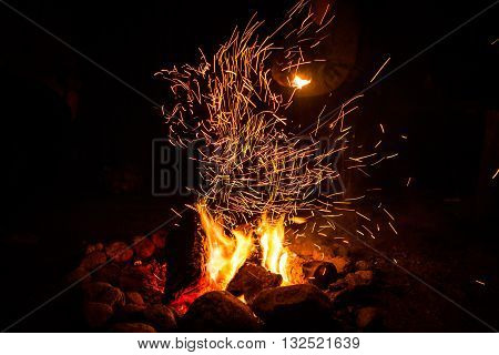 Firepalce with sparks in mountains - Stock Image.