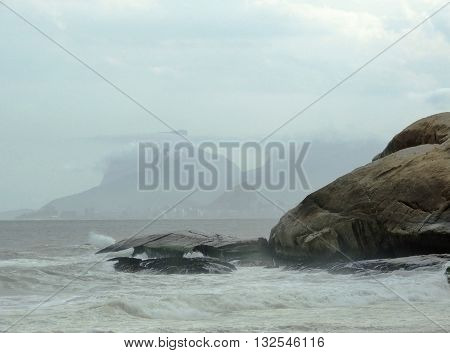 Right end of Camboinhas Beach in Niteroi, Rio de Janeiro, Brazil, on a cloudy day.