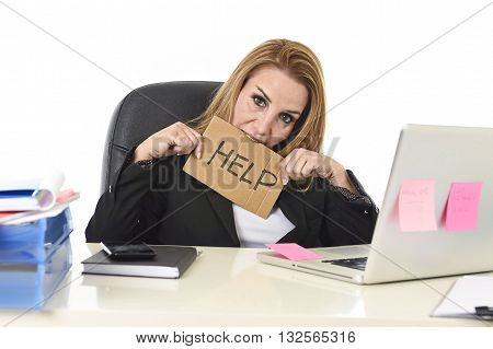 frustrated attractive businesswoman in her 40s holding help sign desparate suffering stress overworked and overwhelmed working at office laptop computer in sad and worried face expression
