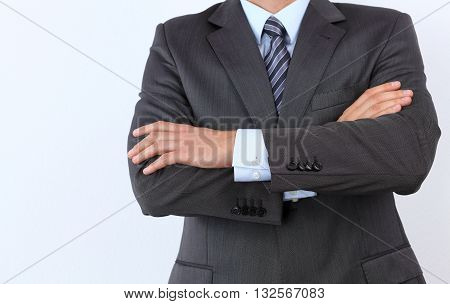 Young , lucky Businessman standing with arms crossed