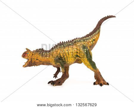side view brown carnotaurus toy on a white background