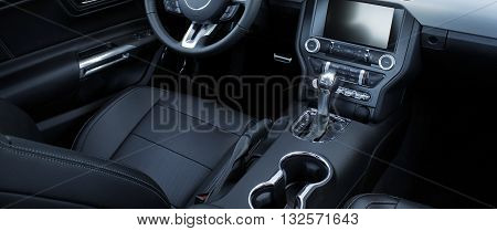 Black leather and chrome parts in car interior