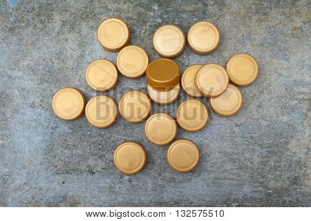 golden plastic bottle cap on stone ground