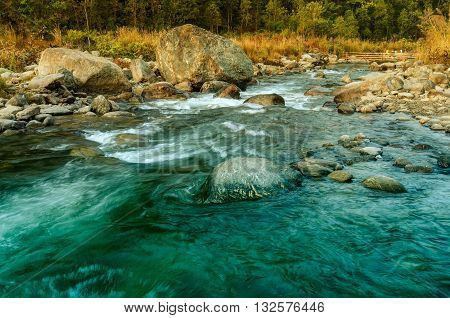 Beautiful Reshi River water flowing through stones and rocks at dawn Sikkim India. Reshi is one of the most famous rivers of Sikkim flowing through the state and serving water to many local people.