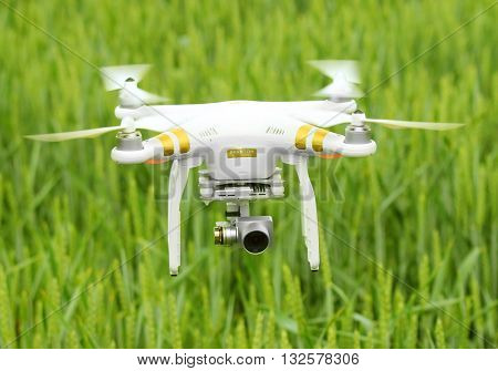 PILSEN CZECH REPUBLIC - JUNE 2, 2016: Drone quadrocopter Dji Phantom 3 Professional with camera. New tool for farmers use drones to inspect of cultivated fields. Modern technology in agriculture.