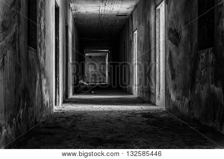 depressed woman sitting on walkway in creepy abandoned building darkness concept