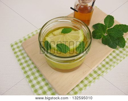Pickled lemons with mint in vinegar in jar