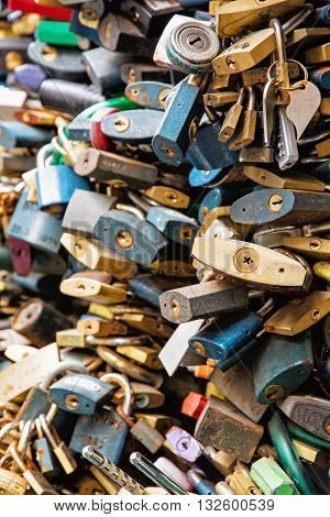 Locks of love. Symbol of lovers. Vertical composition. Many locks. Valentine's Day. Symbolic locks.