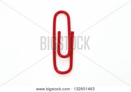 Red paper clip isolated on white background