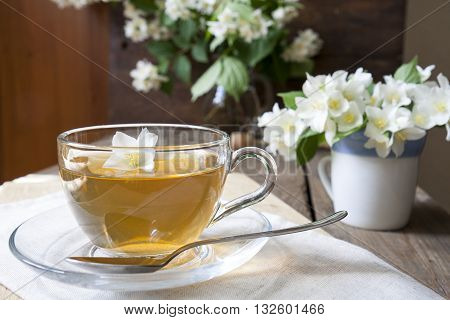 Cup Of Tea With Jasmine And Blooming Jasmine Branch