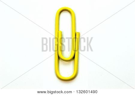 Yellow paper clip isolated on white background