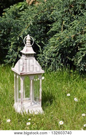 lantern on grass in vintage style. Garden decor