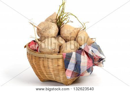 Raw jicamas in basket on white background