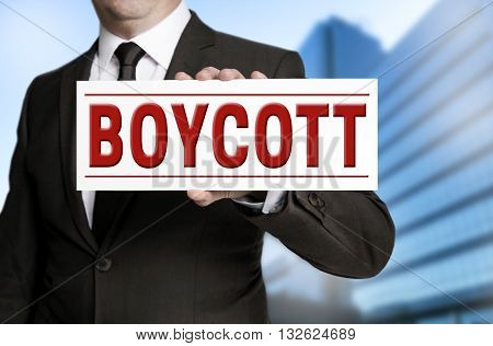 boycott shield is held by businessman background