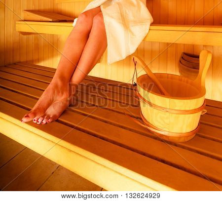 Woman Sitting Relaxed In Wooden Sauna