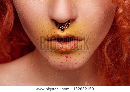 Beautiful Woman with Red Hair and bright makeup. High fashion look close up beauty portrait model with bright makeup with perfect clean skin . High key. nose piercing. creative make-up