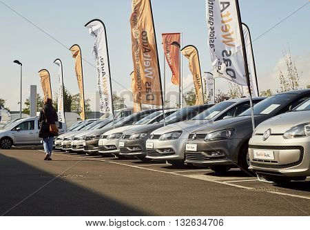 STRASBOURG FRANCE - OCT 10 2015: Woman walking through rows of Volkswagen cars choosing the right model