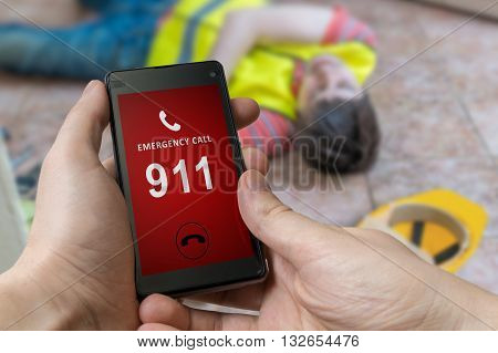 Man Dialing Emergency (911 Number) On Smartphone. Injured Worker