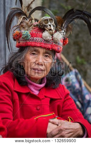 BANAUE PHILIPPINES - JANUARY 24 2014 : Portrait old Filipino woman of Ifugao mountain tribes in national dress next to rice terraces. Ifugao - the mountain people in the Philippines.