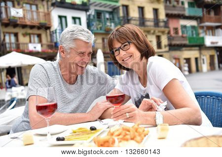 Senior couple eating spanish fingerfood in Spain