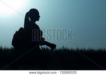 Girl With Photo Camera In Sunset