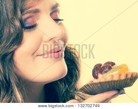 Woman Closed Eyes Holds Cake In Hand