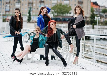 Five Beautiful Young Girls Models At Leather Jackets Posing On Berth.