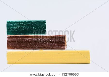 Green, brown and yellow wooden painted blocks stacked blank for copy space